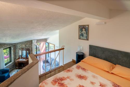 a bedroom with an orange bed and a staircase at Argentarola in Porto Santo Stefano,Pool and Sea View in Porto Santo Stefano