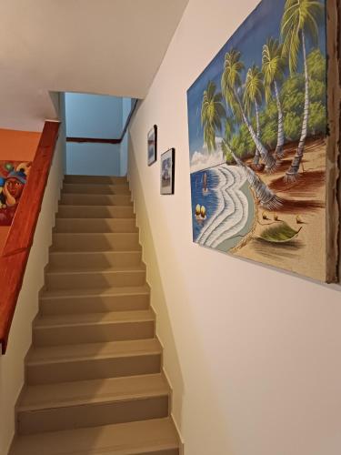 a staircase in a house with a painting on the wall at TropicalHouse in Punta Cana