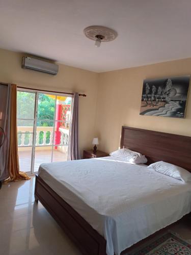 a bedroom with a large bed and a large window at TropicalHouse in Punta Cana