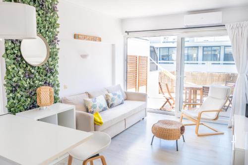 a living room with a couch and a table at Maui Surfer's House Sea view Caparica Beach House in Costa da Caparica
