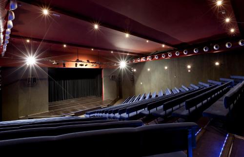 an auditorium of a theatre with chairs and lights at Impressive Playa Granada Golf in Motril