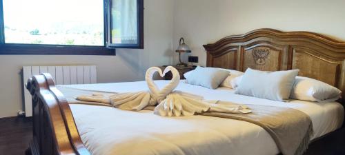 two swans made out of towels sitting on a bed at VILLA DOLARETXE by Urdaibai Rentals in Bilbao