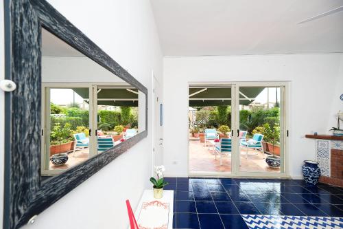 a room with a view of a patio with blue chairs at Villa Torù in Castellabate