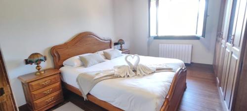 a bedroom with a bed with a bow on it at VILLA DOLARETXE by Urdaibai Rentals in Bilbao