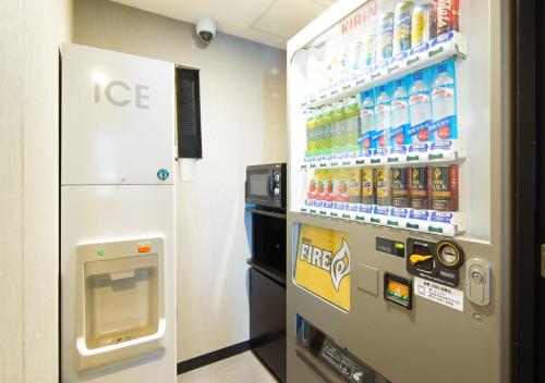 a ice machine in a store with a drink cooler at APA Hotel Sakai Ekimae in Sakai