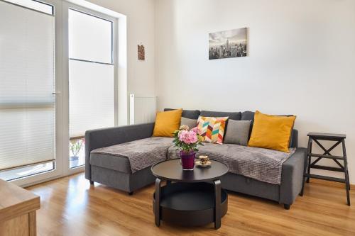 a living room with a couch and a table at Apartmán Jablone in Bytča