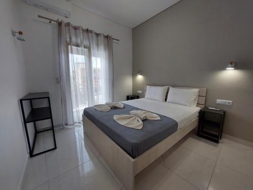 a bedroom with a bed with two towels on it at Apartments Avia in Limenaria