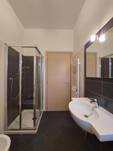 a bathroom with a glass shower and a sink at Casa Vacanze CuprAmare in Cupra Marittima