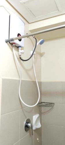 a shower head hanging on the wall of a bathroom at 324 Tower 1 Avida Iloilo Pool View Comfy Cozy Central in Iloilo City