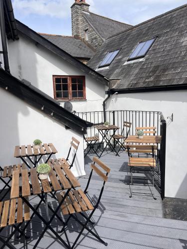 a patio with tables and chairs on a building at The Swan in Bampton