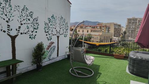a balcony with green grass and a hammock at I Sollazzi in Palermo