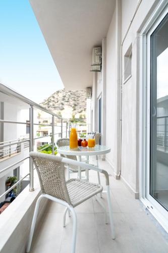 a balcony with a table and oranges on it at Faflagos Apartments in Psari Forada