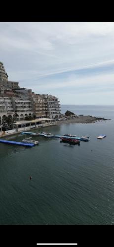 a group of boats in a body of water with buildings at Lux Apartment Meecoon Rafailovići in Rafailovici