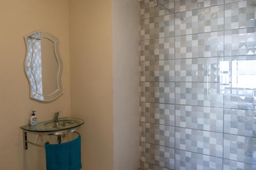 a bathroom with a sink and a glass shower at Blue Star Villa in Tergniet