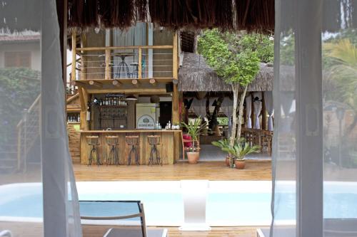 a view of a bar from a window of a resort at Pousada de Charme Emirados in Ilhabela