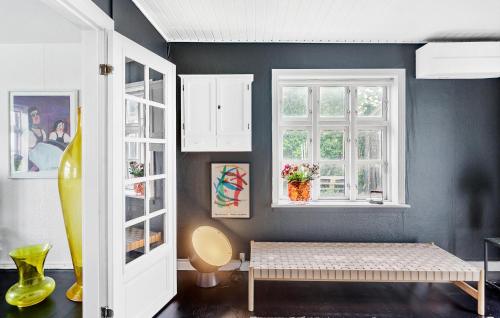 a room with a bench and two windows at Cozy Home In Nørre Alslev With Wifi in Nørre Alslev