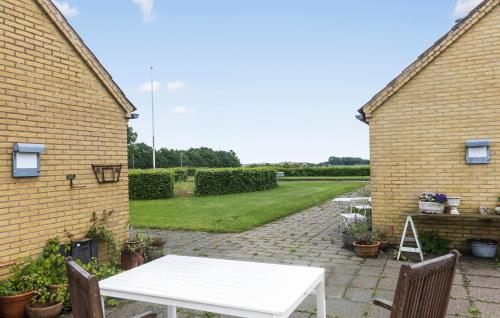 a white table in the courtyard of a house at 1 Bedroom Cozy Home In Nykøbing M in Flade