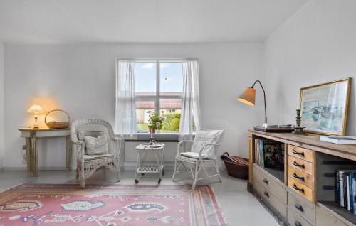 a living room with chairs and a table and a window at 1 Bedroom Cozy Home In Nykøbing M in Flade