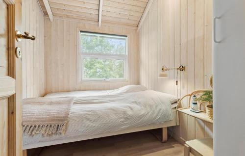 a small bedroom with a bed and a window at 3 Bedroom Gorgeous Home In Ebeltoft in Ebeltoft