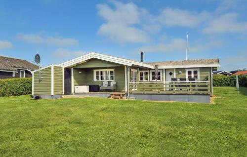 a green house with a lawn in front of it at Stunning Home In Hurup Thy With Wifi in Doverodde