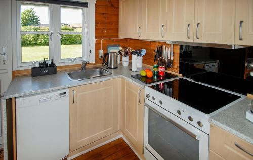 a kitchen with a sink and a stove top oven at Stunning Home In Hurup Thy With Wifi in Doverodde