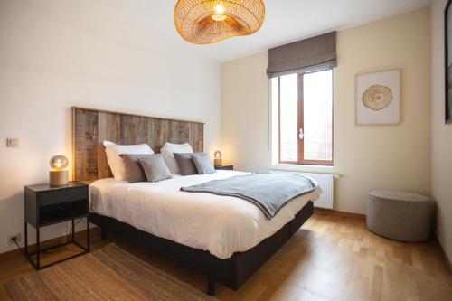 a bedroom with a large bed and a window at Au Cerf & Fagnes in Spa