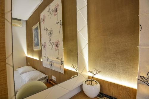 a small bedroom with a mirror and a bed at Epavlis Beach Resort in Porto Heli