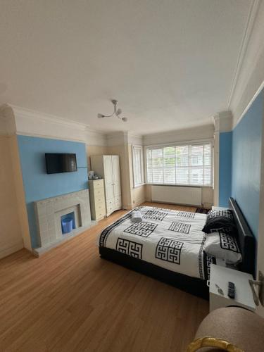 a large bedroom with a bed and a fireplace at Dreamwell Flats in London