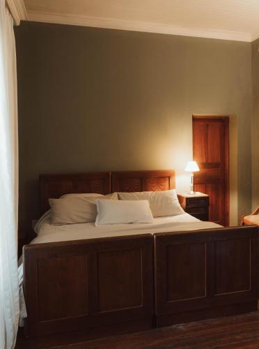 a bedroom with a large bed with white pillows at Estancia La violeta in Chajarí