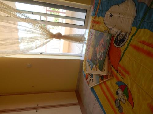 a window in a room with a wall with cartoons on it at Angela's Apartment with beautiful balcony view in Agios Konstantinos Fthiotida