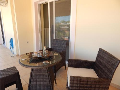 a dining room with a table and chairs and a table and chairs at Angela's Apartment with beautiful balcony view in Agios Konstantinos Fthiotida