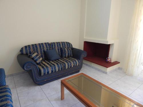 a living room with a couch and a coffee table at Angela's Apartment with beautiful balcony view in Agios Konstantinos Fthiotida