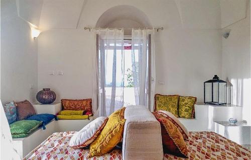 Un dormitorio con una cama con almohadas de colores y una ventana en Stunning Home In Pantelleria With Wifi, en Pantelleria