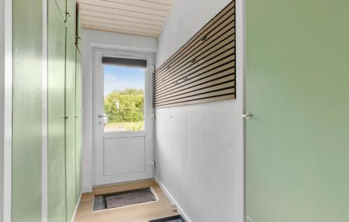 a hallway with a door and a window at 3 Bedroom Beautiful Home In Rønne in Rønne