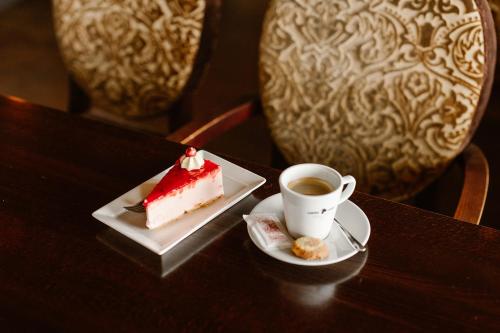 a piece of cake and a cup of coffee on a table at Hotel Restaurant Belvédère in Schoonhoven