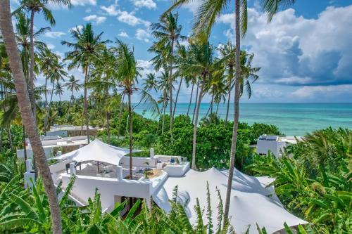 an aerial view of a resort with palm trees and the ocean at Ycona Eco-Luxury Resort, Zanzibar in Dikoni