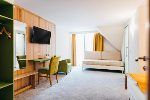 a hotel room with a bed and a desk at Lobogo Resort in Vlăhiţa