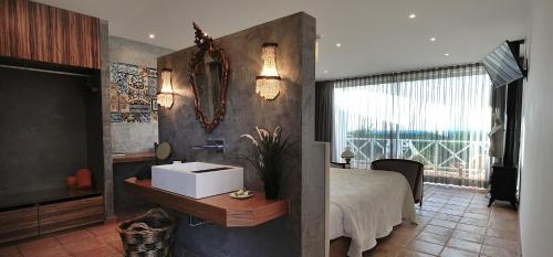 a bathroom with a large bed and a large mirror at A Serenada Enoturismo in Grândola