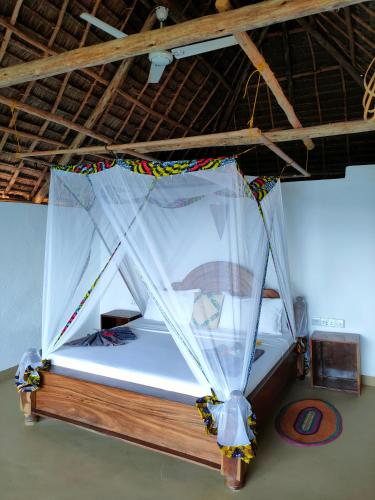 Postel nebo postele na pokoji v ubytování Eden Rock Zanzibar