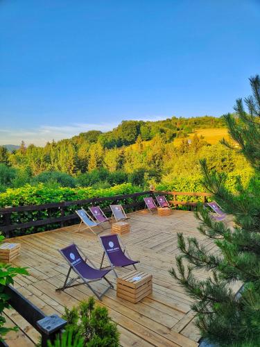 a group of lounge chairs sitting on a patio at Czarna Owca in Istebna