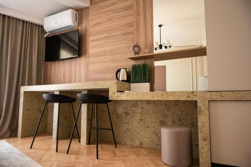 a kitchen with a counter and two stools at Bitola Apartments in Bitola