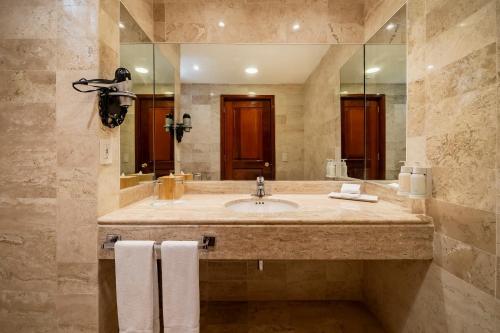 a bathroom with a sink and a large mirror at Iberostar Waves Tucan - All Inclusive in Playa del Carmen