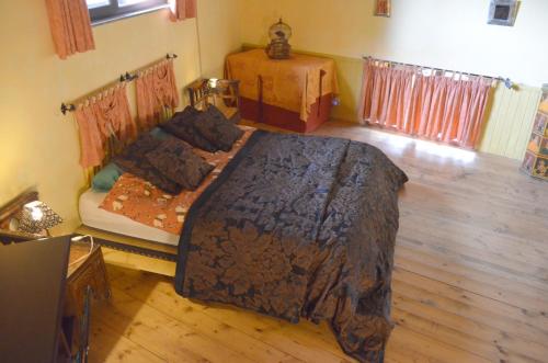 a bedroom with a large bed and a wooden floor at Villa VEDA in Randazzo