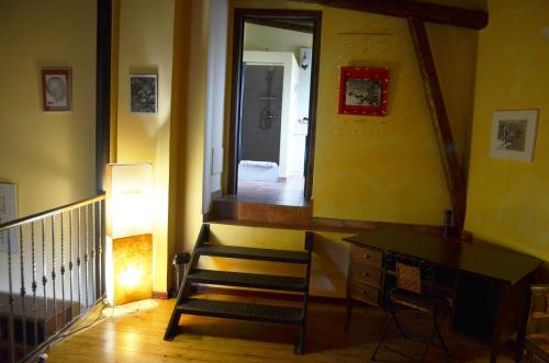 a room with a staircase with a mirror and a desk at Villa VEDA in Randazzo