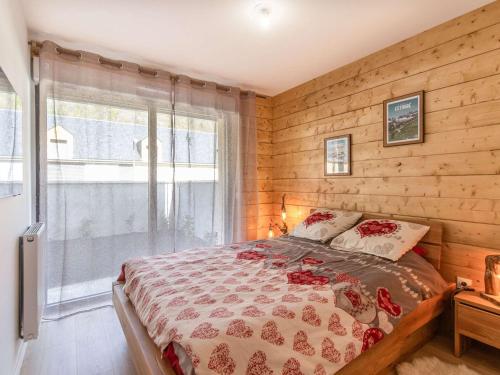 - une chambre avec des murs en bois et un lit avec une fenêtre dans l'établissement Lodge neuf avec grande terrasse et équipement haut de gamme - FR-1-401-292, à Cauterets