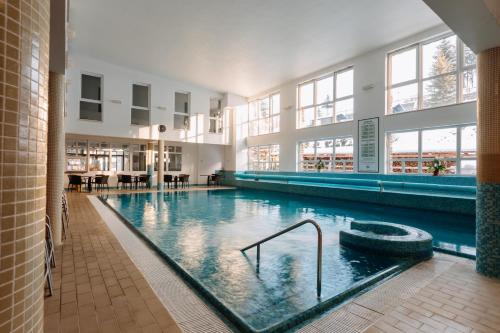a large swimming pool in a building at Lobogo Resort in Vlăhiţa