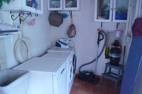 a small kitchen with a washing machine in it at Villa VEDA in Randazzo