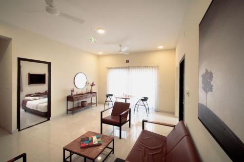 a living room with a couch and a bed and a table at Purple Cloud Urban Bangalore in Bangalore