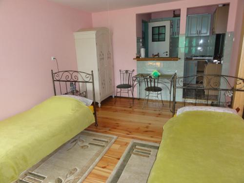 a small room with two beds and a kitchen at Agroturystyka UL in Nowe Worowo