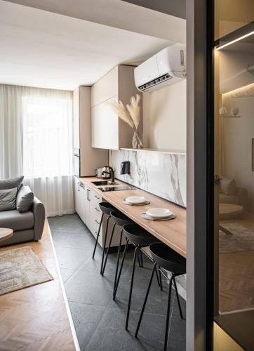 a kitchen with a table and chairs in a room at Bitola Apartments in Bitola